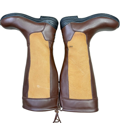 Pair of brown and tan leather boots on a light gray floor.